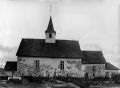 Ramnes kirke i Ramnes er trolig fra 1100-tallet, med våpenhus og tårn fra 1600-tallet. Foto: Ansgar Theodor Larsen (1875–1932), ca. 1930 / Vestfold Fylkesmuseum